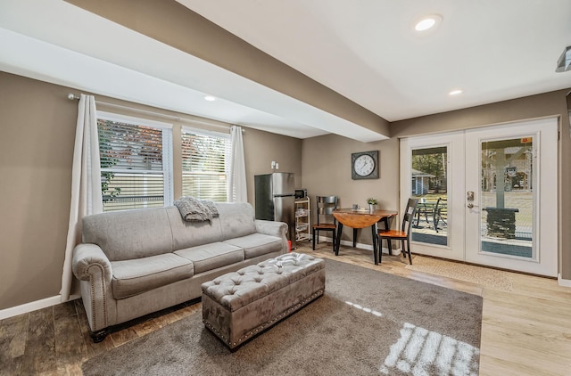 living room with french doors and hardwood / wood-style flooring