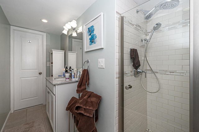 bathroom with vanity, tile patterned floors, and a shower with shower door