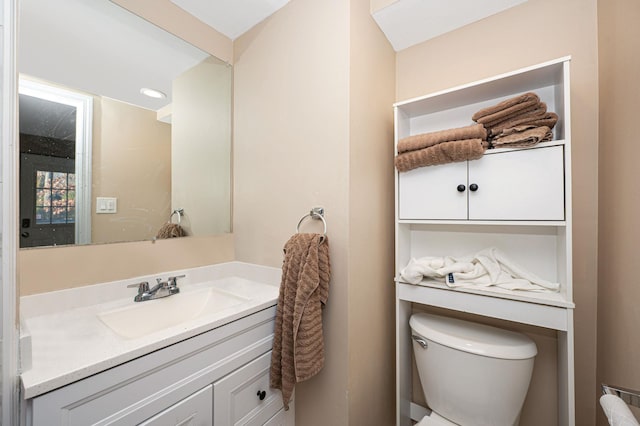 bathroom featuring vanity and toilet