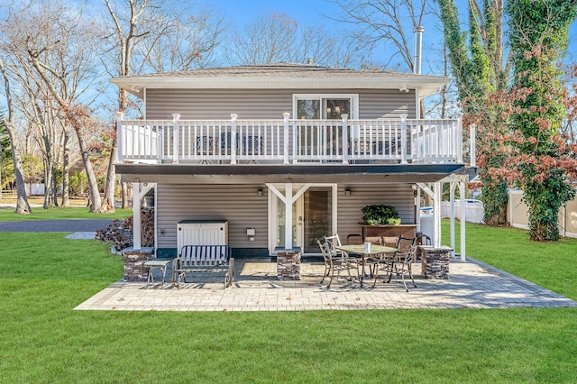 back of property featuring a wooden deck, a yard, and a patio area