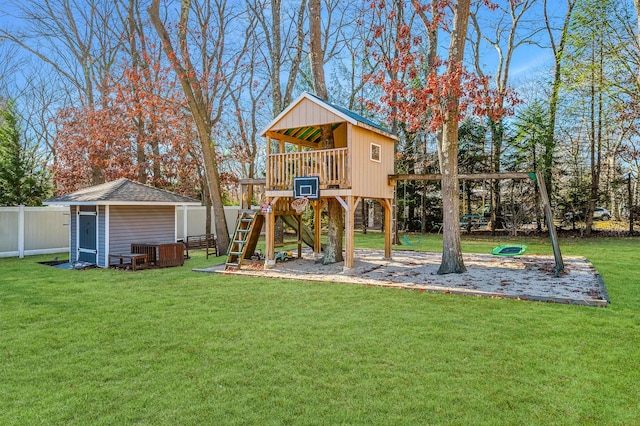 view of yard featuring a storage unit and a playground