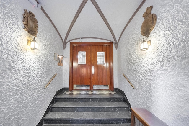 stairs featuring lofted ceiling