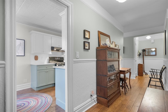 kitchen featuring white cabinetry, range, and light hardwood / wood-style floors