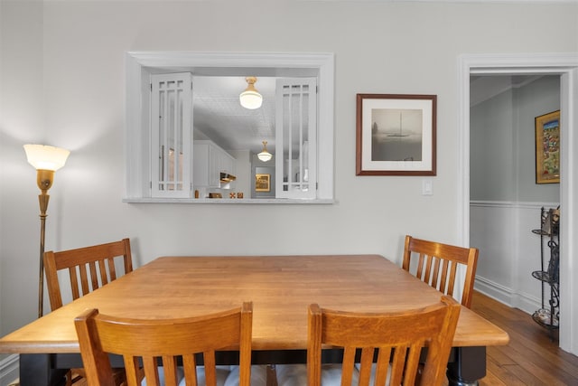 dining space with hardwood / wood-style floors