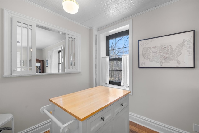 interior space featuring hardwood / wood-style flooring and ornamental molding