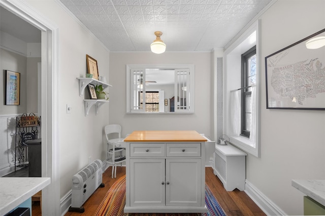 interior space with ornamental molding, plenty of natural light, and dark hardwood / wood-style flooring