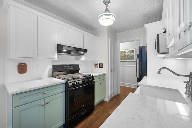 kitchen with black appliances, sink, white cabinets, hanging light fixtures, and green cabinetry