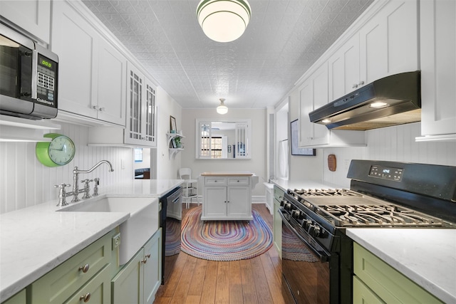 kitchen with hardwood / wood-style floors, white cabinetry, green cabinets, and black appliances