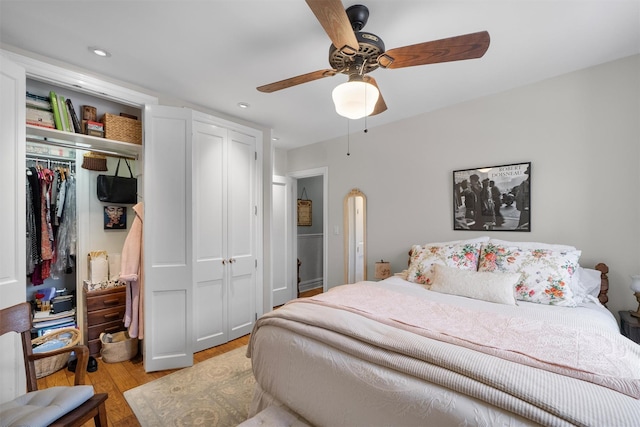 bedroom with ceiling fan, a closet, and light wood-type flooring