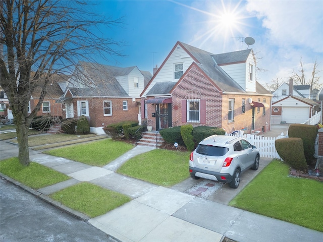 cape cod-style house with a garage and a front yard