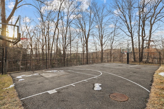 view of basketball court featuring community basketball court and fence