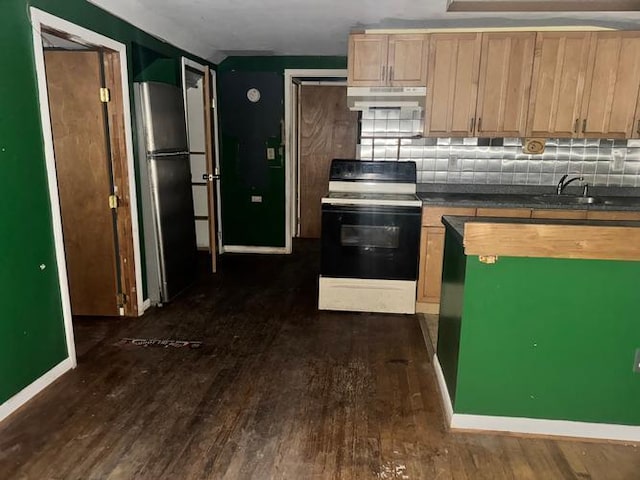 kitchen with electric range, stainless steel fridge, dark wood-type flooring, and light brown cabinets