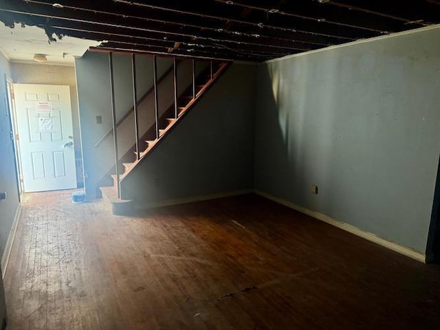 basement with dark hardwood / wood-style floors