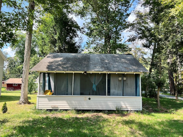 rear view of property with a yard