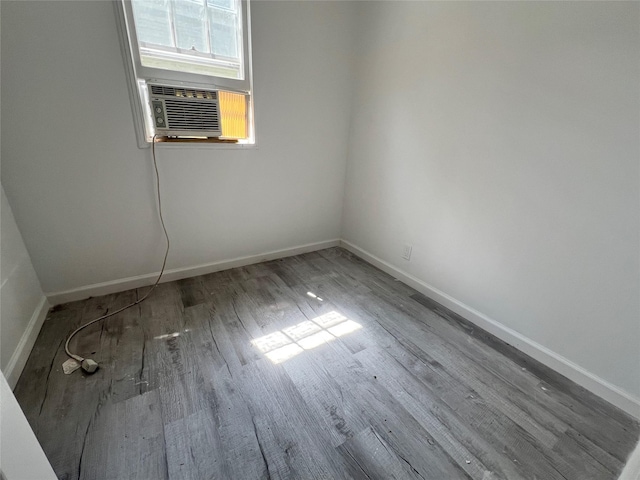 empty room with cooling unit and hardwood / wood-style flooring