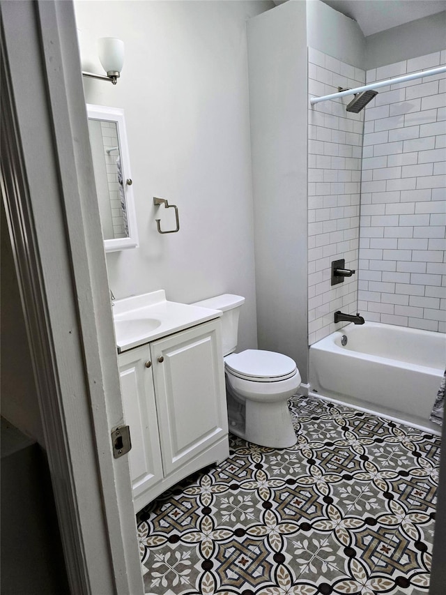 full bathroom featuring vanity, tile patterned floors, toilet, and tiled shower / bath