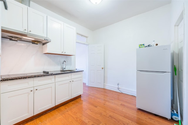 kitchen featuring sink, white appliances, white cabinets, and light wood-type flooring