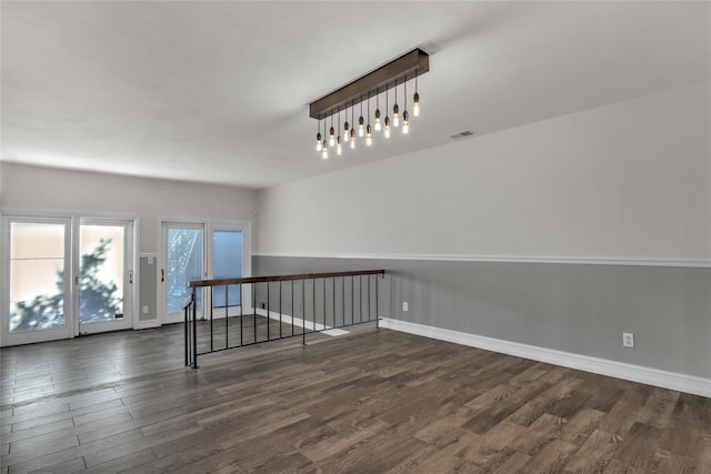 empty room with dark hardwood / wood-style flooring