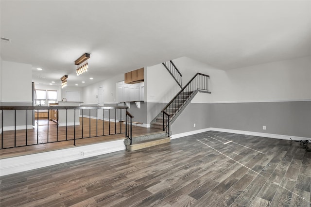 unfurnished room featuring hardwood / wood-style flooring and baseboard heating