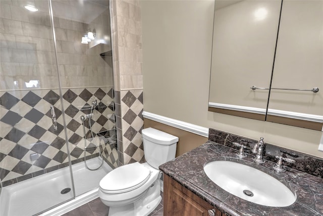 bathroom with an enclosed shower, vanity, and toilet