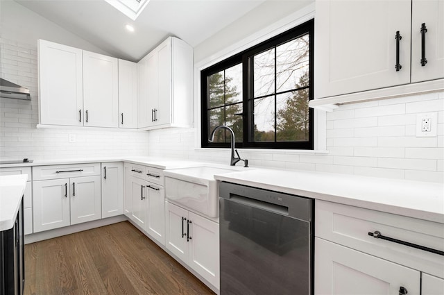 kitchen with dark hardwood / wood-style floors, white cabinetry, dishwasher, lofted ceiling, and sink