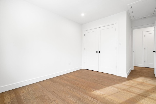 unfurnished bedroom featuring light hardwood / wood-style floors and a closet