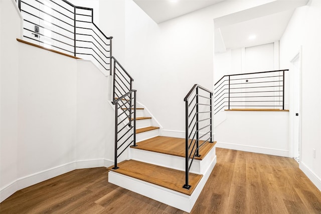 stairs featuring wood-type flooring