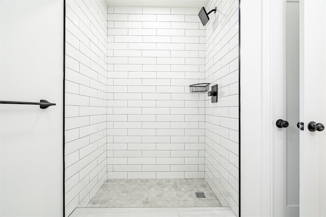 bathroom with a tile shower