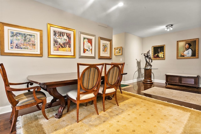 dining room featuring breakfast area and hardwood / wood-style floors