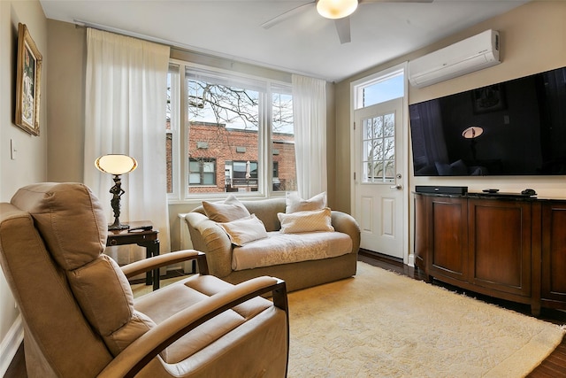 living area featuring ceiling fan, a wall unit AC, and light wood-type flooring