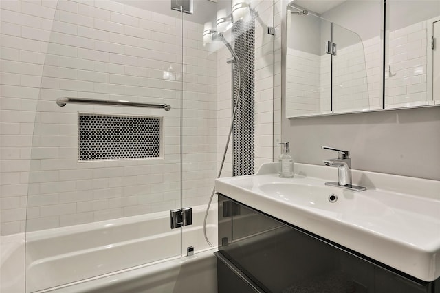 bathroom featuring enclosed tub / shower combo and vanity