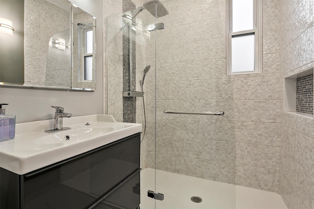 bathroom featuring vanity and a shower with door