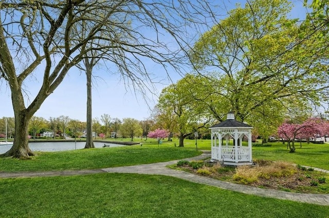 view of community featuring a gazebo, a water view, and a lawn