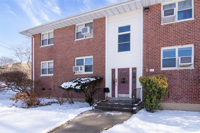 view of front of home featuring cooling unit and a wall unit AC