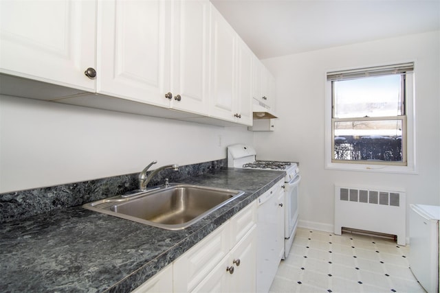 kitchen featuring sink, white appliances, radiator heating unit, and white cabinets