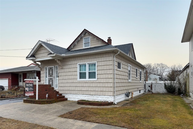 bungalow-style house featuring a lawn