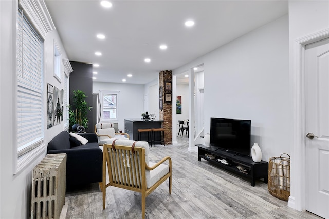 living room featuring radiator heating unit and light wood-type flooring