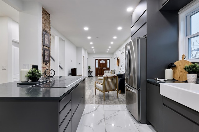 kitchen with stainless steel refrigerator and black electric cooktop