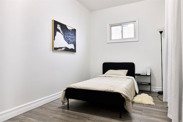 bedroom with hardwood / wood-style flooring