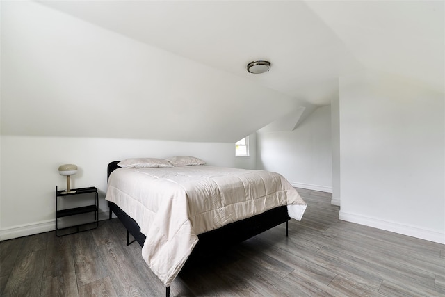 bedroom featuring hardwood / wood-style flooring and lofted ceiling