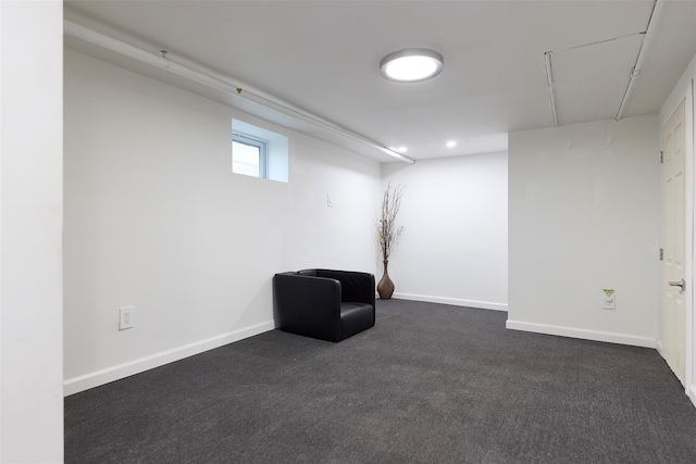 unfurnished room featuring dark carpet