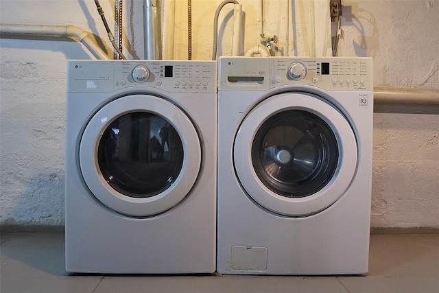 washroom with tile patterned floors and washing machine and dryer