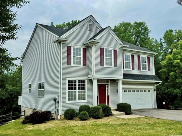 view of front facade with a garage and a front yard