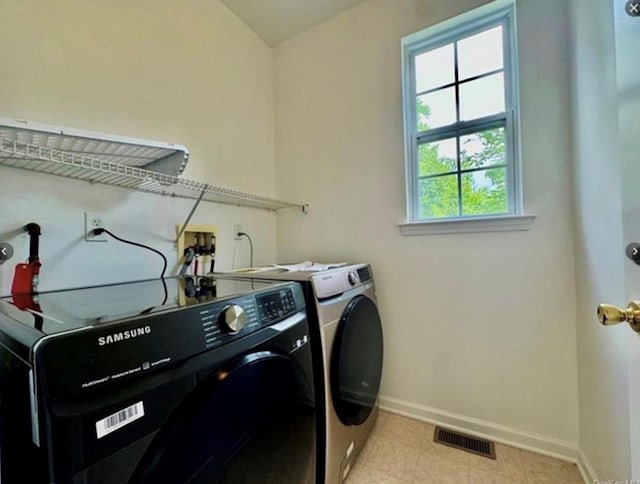 laundry room with separate washer and dryer