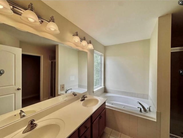 bathroom with tile patterned flooring, vanity, and separate shower and tub