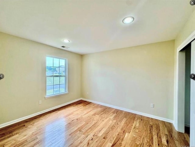 spare room with light hardwood / wood-style floors