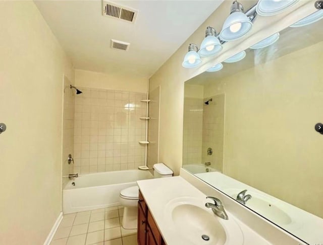 full bathroom with tiled shower / bath combo, vanity, tile patterned floors, and toilet