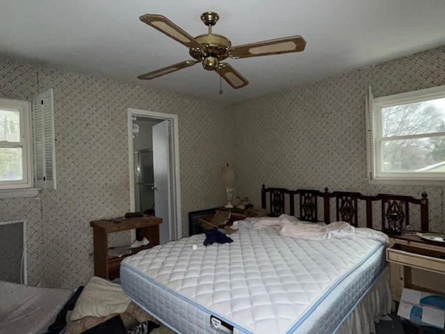 bedroom with multiple windows and ceiling fan