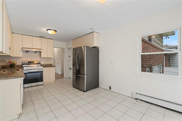 kitchen featuring sink, a baseboard heating unit, stainless steel appliances, cream cabinets, and backsplash