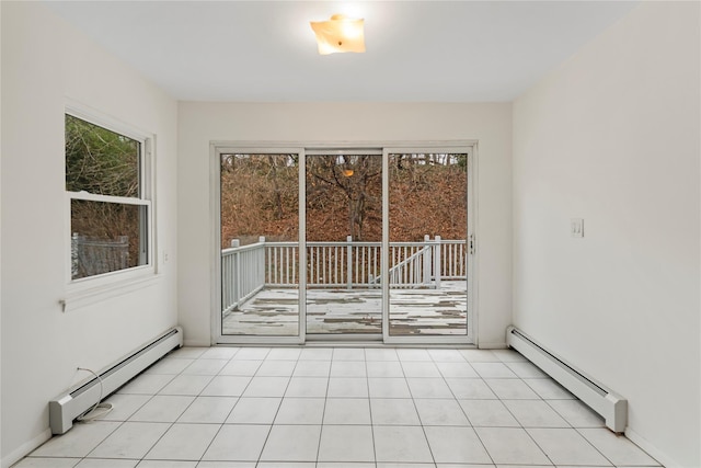 unfurnished room featuring a baseboard heating unit and light tile patterned floors